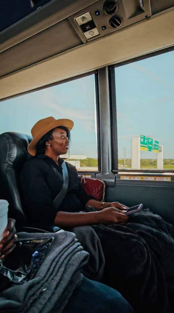 passenger sitting on a winde seat aboard the vonlane dallas bus