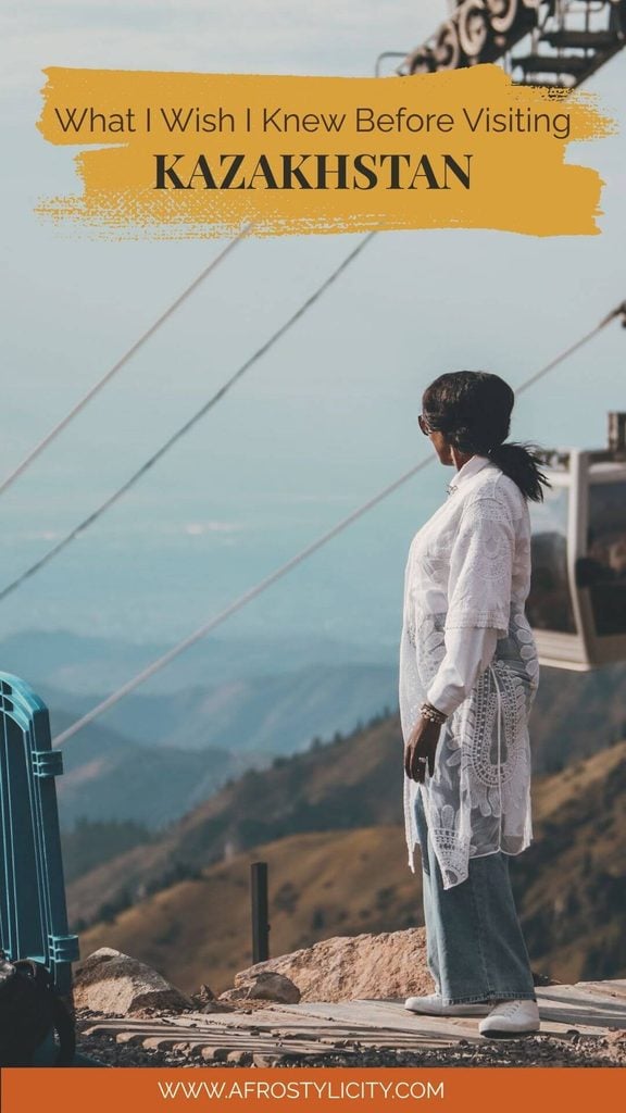 Pinterest graphic about what to know before visiting Kazakhstan, featuring a woman overlooking the mountains near the Shymbulak cable car.