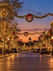 Historic Main Street in Grapevine, Texas, decorated with Christmas garlands, wreaths and glowing holiday lights.