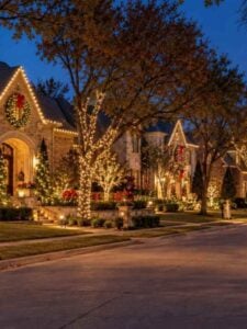 Elegant Plano neighborhood decorated with illuminated trees, Christmas wreaths and warm white lights.
