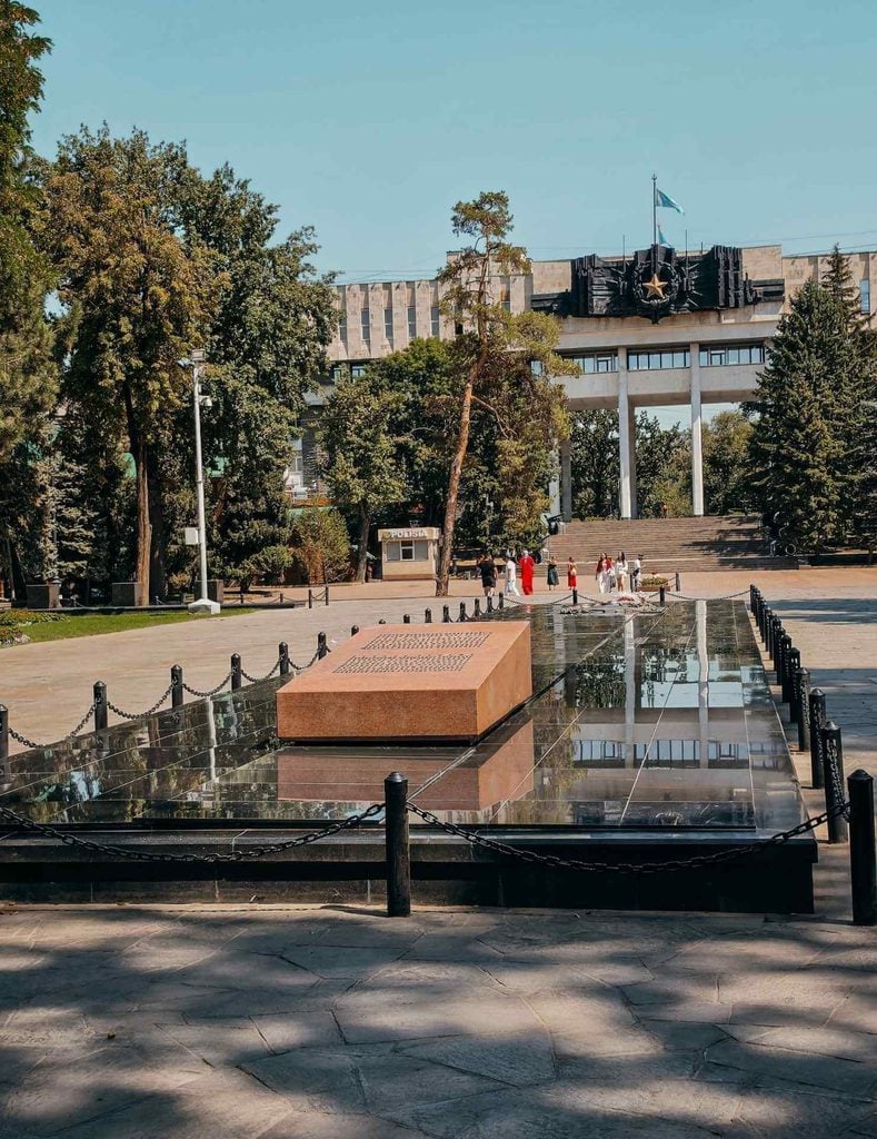 Eternal Flame memorial plaza and commemorative stone at the Memorial of Glory in Panfilov Park, Almaty.
