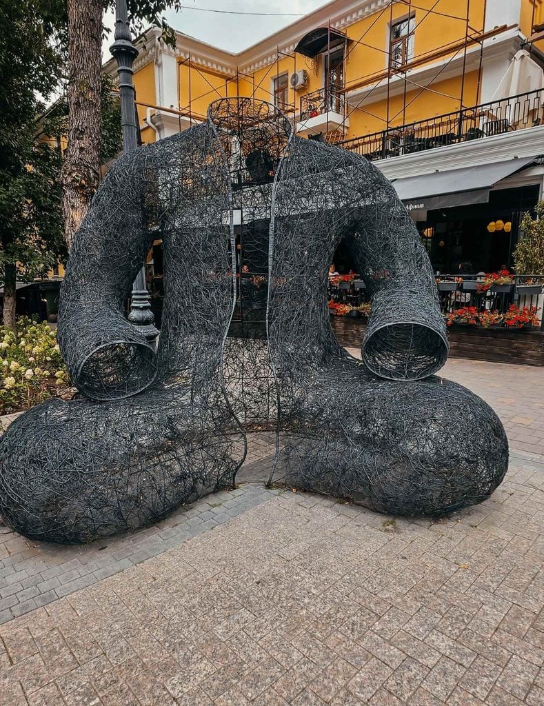 Large Kara Shapan sculpture made from intricately woven black metal on Panfilov Street in Almaty, Kazakhstan.