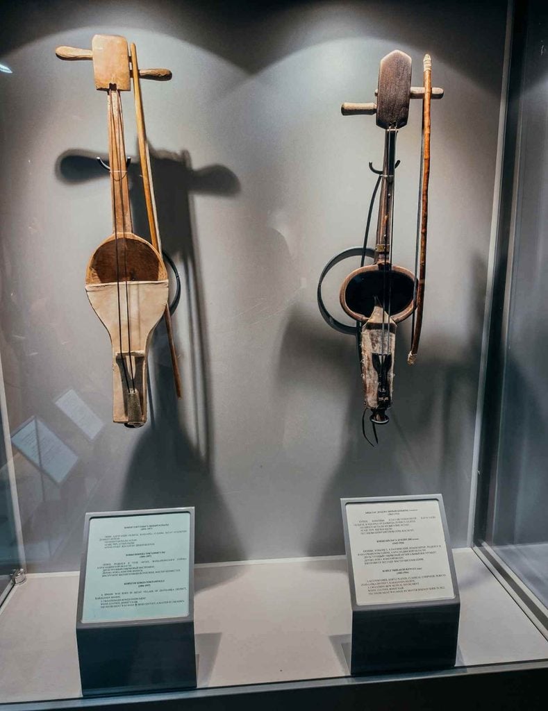 Traditional Kazakh kobyz bowed string instruments displayed inside the Ykhlas Museum in Almaty.
